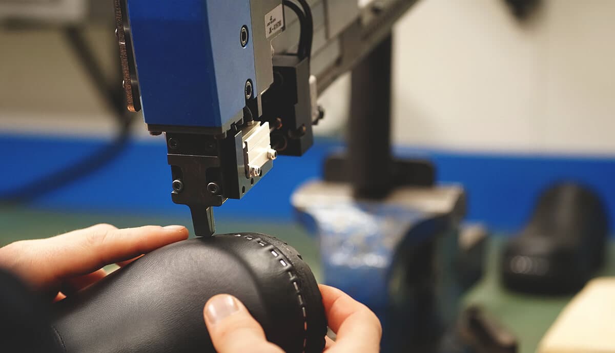 Man making clogs with stapler