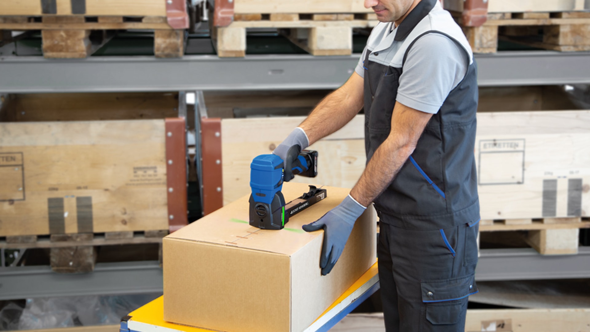 Man closing cartons in warehouse